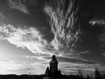 Low angle view of statue against sky at sunset