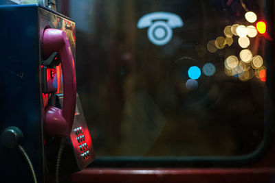 Close-up of illuminated telephone booth at night