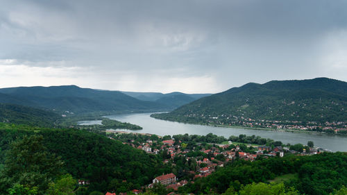 High angle view of townscape by mountains against sky