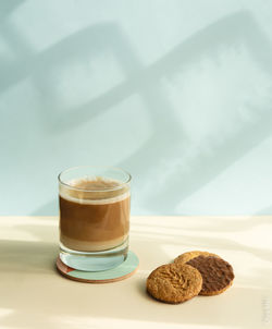 Coffee cup and cookies on table