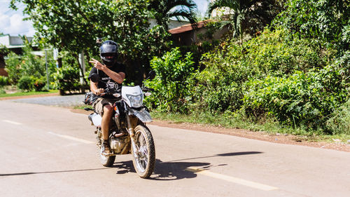 Man riding bicycle on road in city