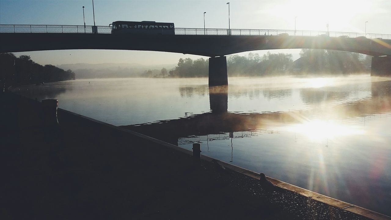 water, bridge - man made structure, connection, built structure, sun, river, architecture, sunset, reflection, engineering, sunbeam, sunlight, transportation, bridge, sky, travel destinations, tourism, lens flare, travel, nature