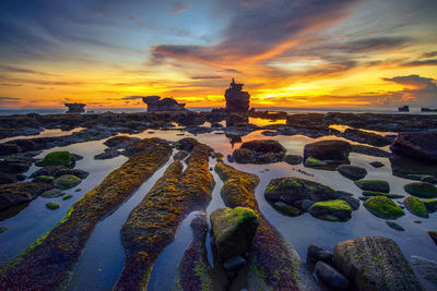 Scenic view of beach against sky during sunset