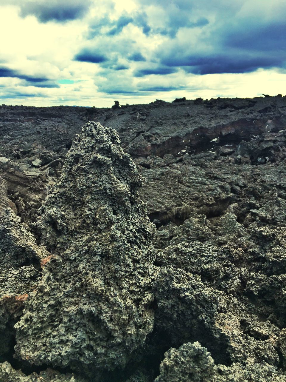 sky, scenics, tranquil scene, cloud - sky, tranquility, rock - object, nature, beauty in nature, cloud, non-urban scene, distant, remote, mountain, cloudy, day, outdoors, vacations, sea, rocky, physical geography, rock formation, solitude, dramatic landscape, tourism, rugged