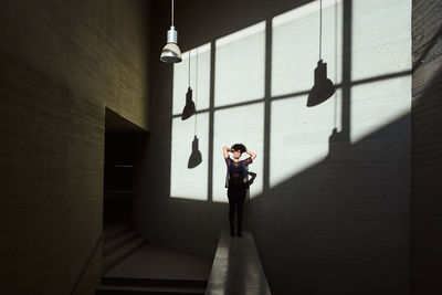 Woman sunbathing inside a building