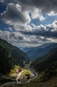 Scenic view of mountains against cloudy sky