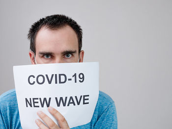 Portrait of young man against white background