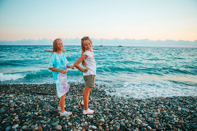 Full length of woman standing on beach