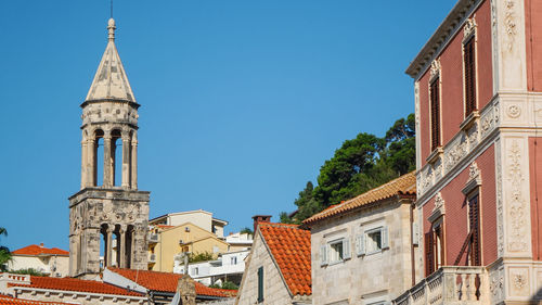 Low angle view of building against clear blue sky