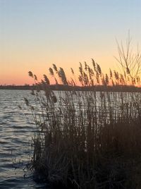 Scenic view of lake against sky during sunset