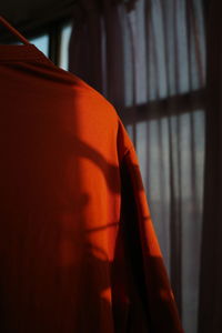 Close-up of orange hand on window