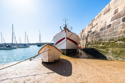 Sailboat moored on sea against sky