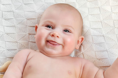 Beautiful baby on white blanket. head and face. newborn baby. motherhood. adorable small child. 