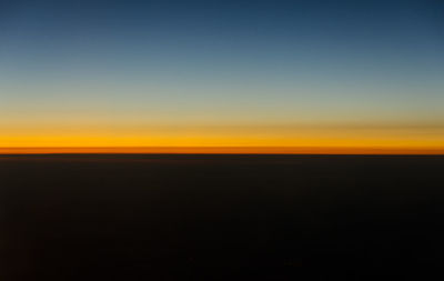 Scenic view of landscape against clear sky during sunset