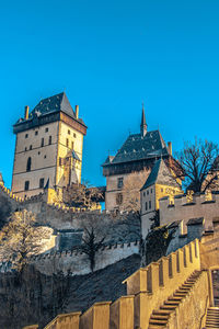 Low angle view of buildings against clear blue sky