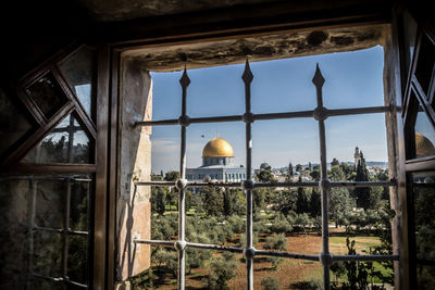 Low angle view of glass building against sky