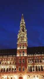 Low angle view of illuminated building against sky at night