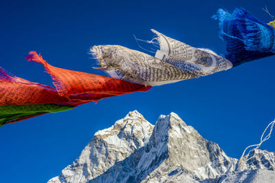 Low angle view of mountain against clear blue sky