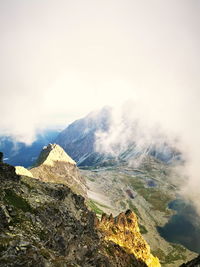 Mountain valley in the clouds lit by the setting sun. tatra mountains slovakia.