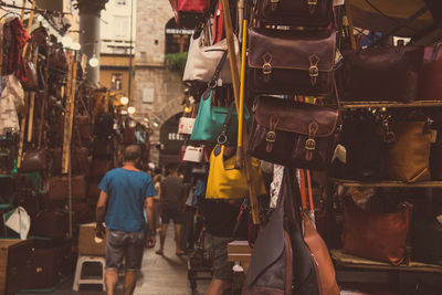 Man walking amidst stores at market