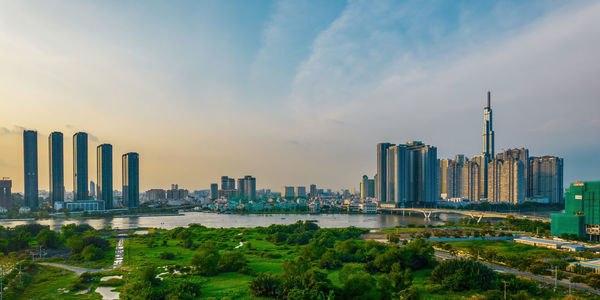 Panoramic view of buildings in city against cloudy sky