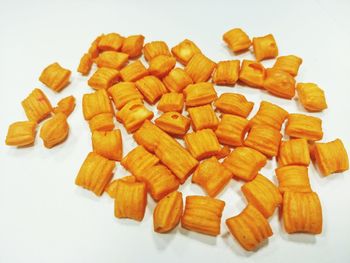 High angle view of chopped vegetables on table against white background