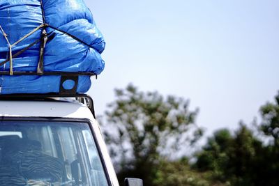 Rear view of a car against blue sky