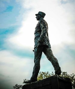 Low angle view of statue against sky