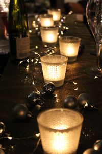 Close-up of illuminated tea light candle on table