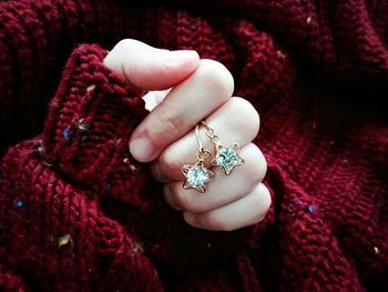 Close-up of woman hand holding star shape pendants