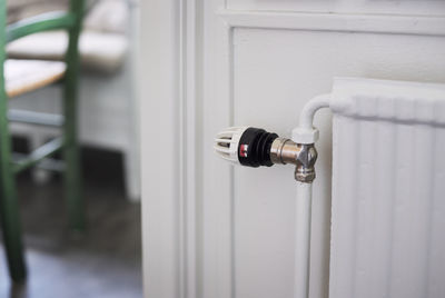 Close-up of radiator with thermostat