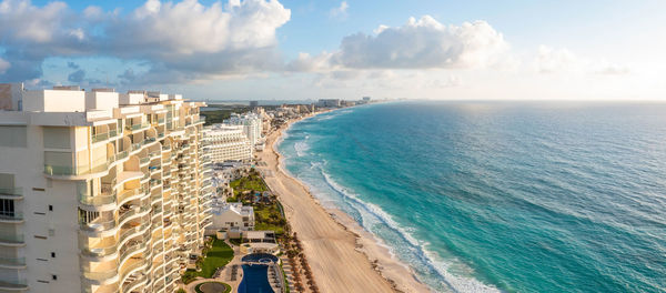 Panoramic view of sea and buildings against sky