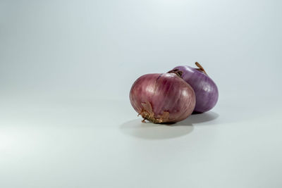 Close-up of fruits on table against white background