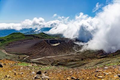 Scenic view on volcanic landscape, clouds in aso crater, aso town in kyushu, japan