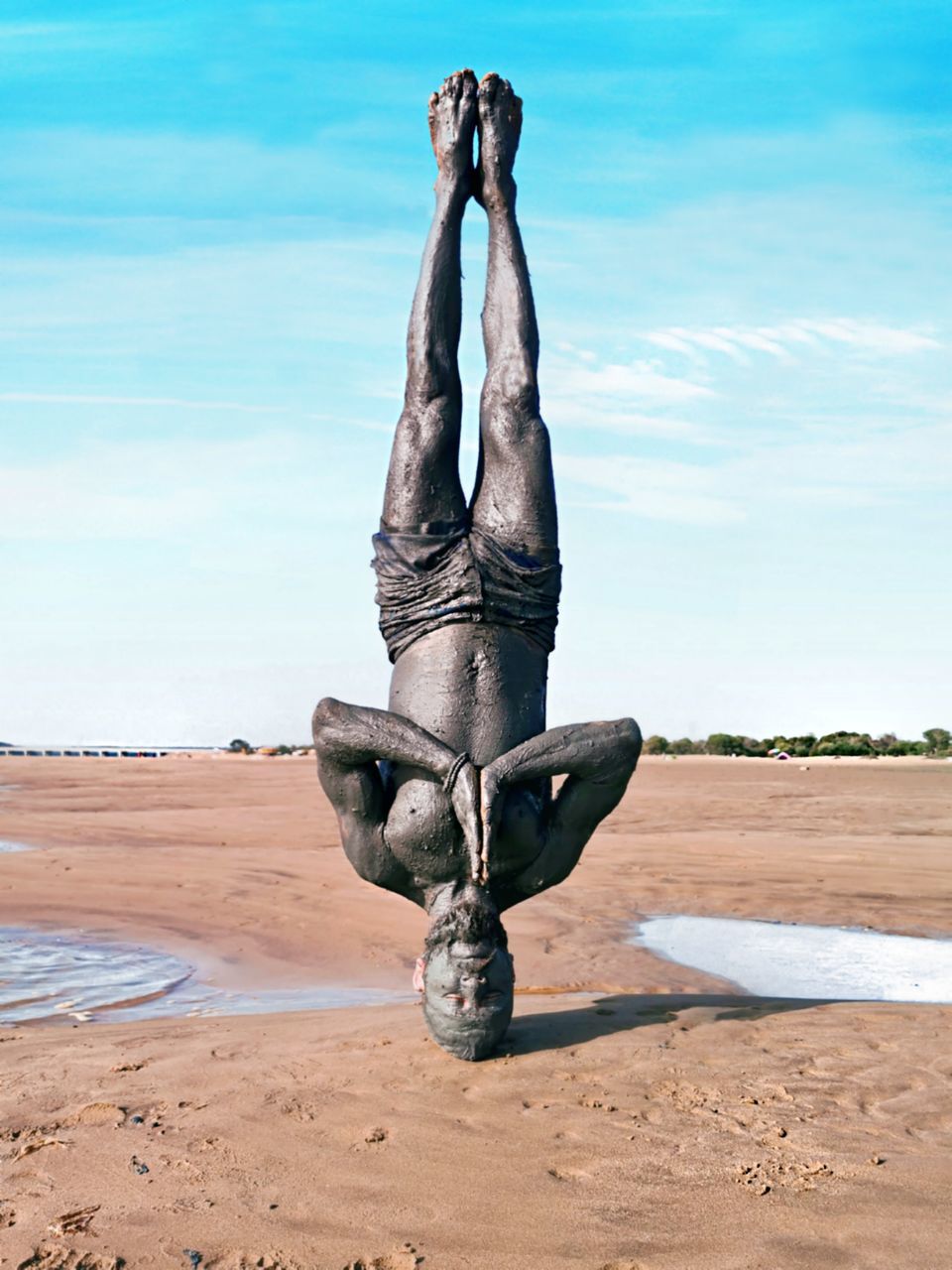 land, sky, sand, day, beach, nature, sea, art and craft, tranquil scene, beauty in nature, water, sculpture, tranquility, human arm, cloud - sky, arms raised, outdoors, scenics - nature, horizon, handstand