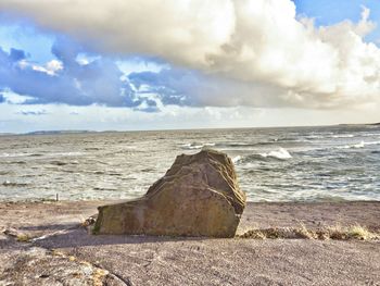 Scenic view of sea against cloudy sky