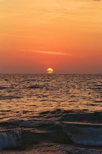 Scenic view of sea against romantic sky at sunset