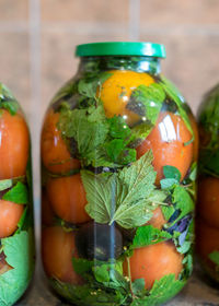 Close-up of orange fruit in glass jar