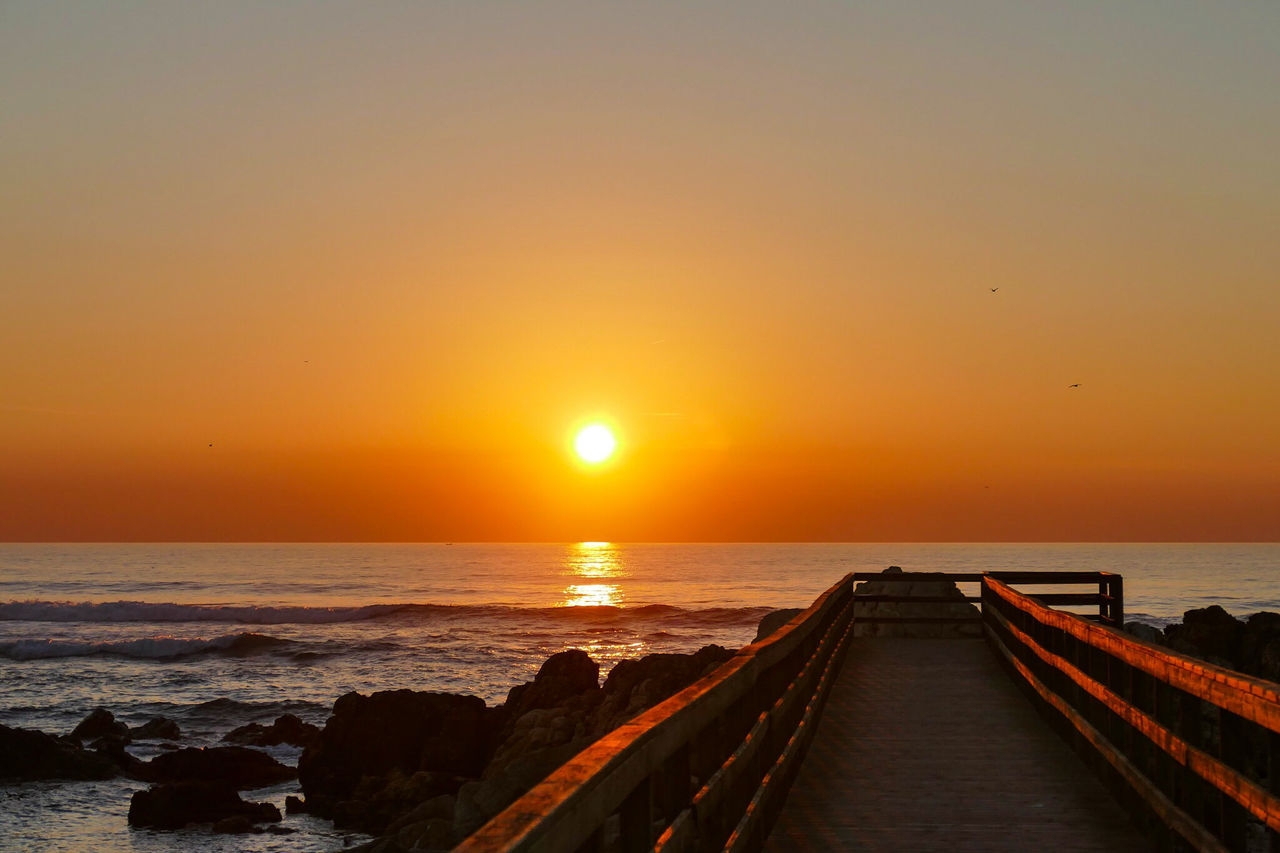 water, sky, sunset, sea, scenics - nature, horizon over water, beauty in nature, horizon, sun, orange color, tranquility, tranquil scene, beach, idyllic, nature, land, sunlight, no people, the way forward, outdoors, bright