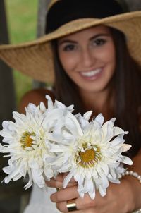 Portrait of beautiful young woman with white flowers