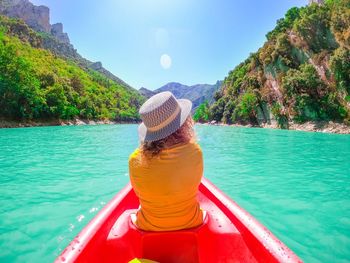 Rear view of woman in boat in lake