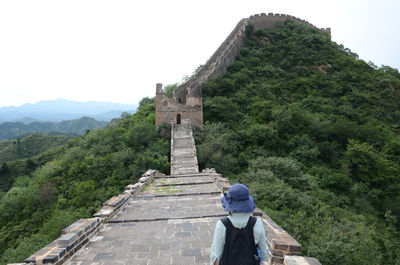 Woman walking on great wall of china at jinshanling