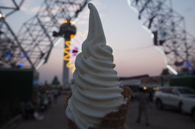 Close-up of ice cream cone against sky