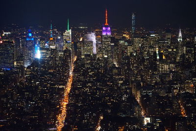 Aerial view of illuminated cityscape and empire state building at night