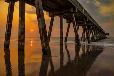 Silhouette pier on sea against sky during sunset