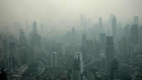 Buildings in city during foggy weather