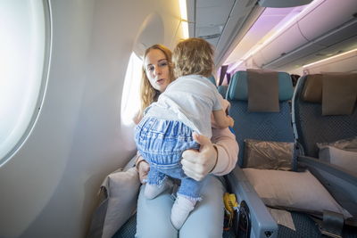 Portrait of mother with daughter at airplane