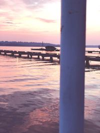 Bridge over river against sky during sunset