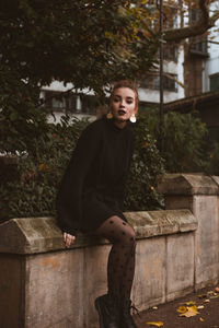 Portrait of young woman sitting on staircase