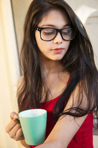 Young woman holding coffee cup